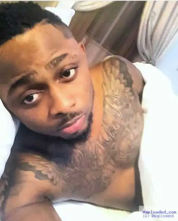 Nigerian Artiste, Sean Tizzle Shows Off His Chest Tattoo In New Bedroom Selfie